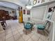 Bright dining area with glass table and four chairs, adjacent to kitchen at 3721 Monday Ter, North Port, FL 34286