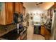 Updated kitchen with wood cabinets, granite countertops, and black appliances at 3721 Monday Ter, North Port, FL 34286
