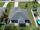 House with grey roof, paved patio, screened porch, and fenced yard at 3721 Monday Ter, North Port, FL 34286