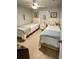 Cozy bedroom with two twin beds, nightstand, and ceiling fan at 3721 Monday Ter, North Port, FL 34286