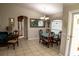Bright dining area with round table and four chairs, view of kitchen and living room at 3721 Monday Ter, North Port, FL 34286
