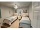 Bright bedroom with two twin beds, nightstand, and ceiling fan at 3721 Monday Ter, North Port, FL 34286