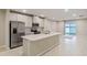 Open concept kitchen with island, stainless steel appliances, and white cabinets at 1781 W Palms Dr, Port Charlotte, FL 33953