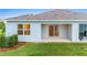 Home exterior showcasing a covered patio and grassy backyard at 1781 W Palms Dr, Port Charlotte, FL 33953