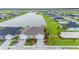 Aerial view showcasing a house with a two-car garage and a landscaped yard at 1781 W Palms Dr, Port Charlotte, FL 33953