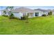House with a covered patio and a large grassy backyard at 1781 W Palms Dr, Port Charlotte, FL 33953