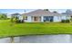 Single-story home with covered patio and lake access at 1781 W Palms Dr, Port Charlotte, FL 33953