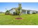 Backyard patio, grassy lawn, and birds at 1781 W Palms Dr, Port Charlotte, FL 33953