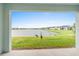 Spacious backyard with pond view, lush grass, and birds at 1781 W Palms Dr, Port Charlotte, FL 33953