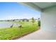 Spacious backyard with pond view, lush grass, and birds at 1781 W Palms Dr, Port Charlotte, FL 33953