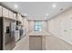 Open concept kitchen with island, stainless steel appliances, and white cabinets at 1781 W Palms Dr, Port Charlotte, FL 33953