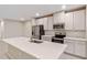 Modern kitchen with white cabinets, quartz countertops, and stainless steel appliances at 1781 W Palms Dr, Port Charlotte, FL 33953