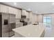 Open concept kitchen with island, stainless steel appliances, and white cabinets at 1781 W Palms Dr, Port Charlotte, FL 33953