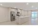 Spacious kitchen with island, stainless steel appliances, and white cabinets at 1781 W Palms Dr, Port Charlotte, FL 33953