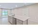 Open concept kitchen with island, stainless steel appliances, and white cabinets at 1781 W Palms Dr, Port Charlotte, FL 33953