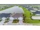 Aerial view of a house with double garage and landscaped front yard by lake at 1781 W Palms Dr, Port Charlotte, FL 33953