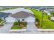 Aerial view of a house with a double garage and landscaped front yard at 1781 W Palms Dr, Port Charlotte, FL 33953