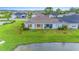 Aerial view of a house with backyard and covered patio near a lake at 1781 W Palms Dr, Port Charlotte, FL 33953