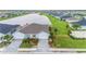 Aerial view of a home with a two-car garage and landscaped yard at 1781 W Palms Dr, Port Charlotte, FL 33953
