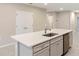 Kitchen island with white quartz countertop and sink at 1781 W Palms Dr, Port Charlotte, FL 33953