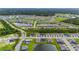 Aerial view of a sprawling community featuring numerous homes and water features at 1781 W Palms Dr, Port Charlotte, FL 33953