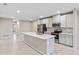 Open concept kitchen with island, stainless steel appliances, and white cabinets at 1781 W Palms Dr, Port Charlotte, FL 33953