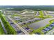 Aerial view of a large community with houses, lakes, and lush greenery at 1781 W Palms Dr, Port Charlotte, FL 33953