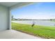 Spacious backyard with pond view, lush grass, and birds at 1781 W Palms Dr, Port Charlotte, FL 33953