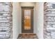 Modern front door with glass panel and stone accents at 1781 W Palms Dr, Port Charlotte, FL 33953