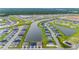 Aerial view showing a community of homes surrounding a tranquil lake at 1781 W Palms Dr, Port Charlotte, FL 33953