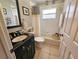 Clean bathroom with tub, shower, vanity, and dark-colored countertop at 3721 Monday Ter, North Port, FL 34286