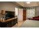 King-size bed, large TV, and ensuite bathroom access from bedroom at 3721 Monday Ter, North Port, FL 34286