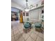 Bright breakfast nook with glass-top table and teal chairs at 3721 Monday Ter, North Port, FL 34286