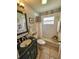 Clean bathroom with tub, shower, vanity, and dark-colored countertop at 3721 Monday Ter, North Port, FL 34286