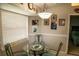 Kitchen nook with glass-top table and chairs, window coverings, and lighting at 3721 Monday Ter, North Port, FL 34286