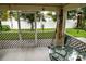 Relaxing screened porch with glass table and backyard view at 3721 Monday Ter, North Port, FL 34286