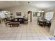 Open living and dining room with tile floors and brown couch at 3721 Monday Ter, North Port, FL 34286