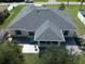 Aerial view of house featuring a grey roof and paved patio at 3721 Monday Ter, North Port, FL 34286