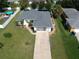 Single story house with grey roof, paved driveway and a fenced-in backyard at 3721 Monday Ter, North Port, FL 34286