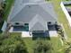 Aerial view of house with paved patio and screened-in porch at 3721 Monday Ter, North Port, FL 34286