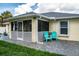 Home's back exterior showcasing patio and screened porch at 3721 Monday Ter, North Port, FL 34286
