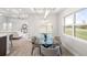Modern dining room with glass table and four chairs, open to living room at 13493 Los Angeles Ave, Port Charlotte, FL 33981