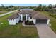 New construction home with a modern design, landscaped yard, and paved driveway at 13493 Los Angeles Ave, Port Charlotte, FL 33981