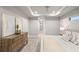 Main bedroom with dresser and large bed, access to bathroom and hallway at 13493 Los Angeles Ave, Port Charlotte, FL 33981