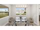 Modern dining room with glass table and four chairs at 13493 Los Angeles Ave, Port Charlotte, FL 33981