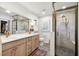 Modern bathroom with double vanity, large shower, and stylish tile at 404 Firethorn Ave, Englewood, FL 34223