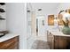 Modern bathroom with a walk-in shower and dark wood vanity at 404 Firethorn Ave, Englewood, FL 34223