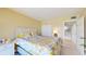 Bedroom with floral bedding and access to hallway at 25188 Marion Ave # D101, Punta Gorda, FL 33950