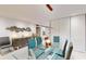 Modern glass dining table with six chairs and a stylish light fixture at 25188 Marion Ave # D101, Punta Gorda, FL 33950
