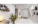 Bright and airy entryway with decorative wall art and built-in shelving at 25188 Marion Ave # D101, Punta Gorda, FL 33950
